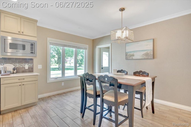 240 Red Oak Ln, Rochester Hills, MI 48307 - dining area featuring light wood-style flooring, a chandelier, and crown molding