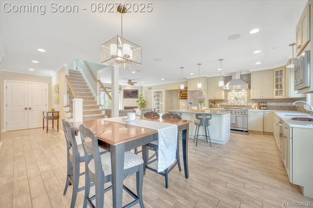 240 Red Oak Ln, Rochester Hills, MI 48307 - dining room with stairs, ornamental molding, light wood-style floors, recessed lighting, and a chandelier
