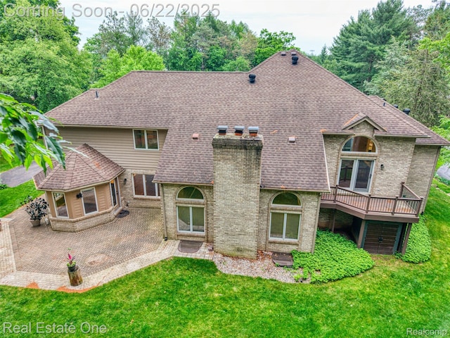 5258 Hidden Pines Dr, Brighton, MI 48116 - back of property with a chimney, a patio area, a yard, brick siding, and a wooden deck