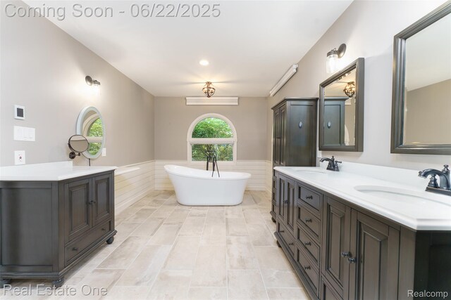 5258 Hidden Pines Dr, Brighton, MI 48116 - full bathroom with wainscoting, double vanity, and a freestanding bath