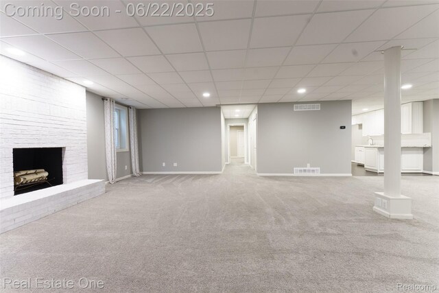 5258 Hidden Pines Dr, Brighton, MI 48116 - unfurnished living room with a fireplace, carpet floors, recessed lighting, and a drop ceiling