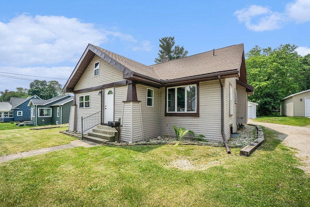 59 Dunning Ave, Battle Creek, MI 49037 - view of front of home with a front lawn, dirt driveway, roof with shingles, and entry steps