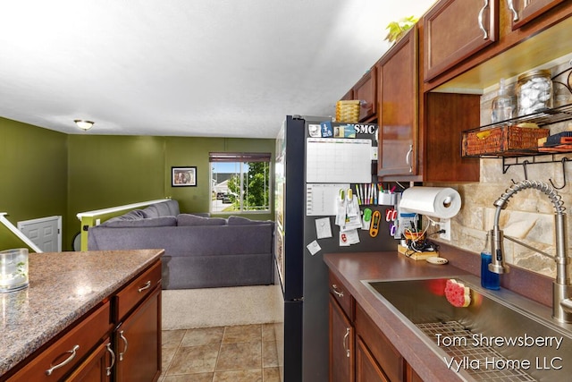 16304 Trent Ridge Dr, Cedar Springs, MI 49319 - kitchen featuring freestanding refrigerator, decorative backsplash, dark countertops, and open floor plan