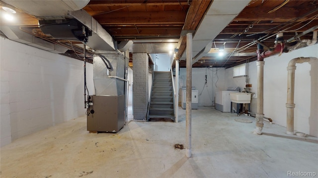 929 Kettering Ave, Pontiac, MI 48340 - basement featuring washer / dryer, heating unit, and stairway