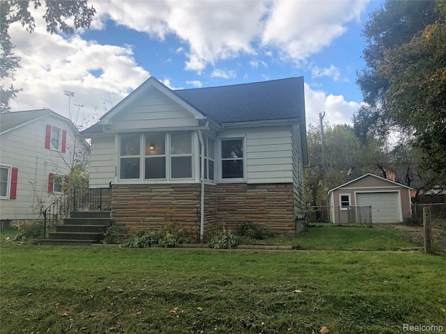 929 Kettering Ave, Pontiac, MI 48340 - view of front of house featuring a garage, stone siding, a front yard, and roof with shingles
