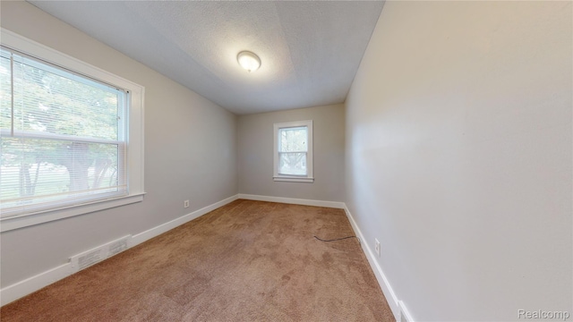 929 Kettering Ave, Pontiac, MI 48340 - empty room with light colored carpet and a textured ceiling