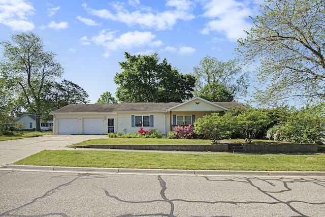 632 Green St, South Haven, MI 49090 - view of front of house featuring concrete driveway, a garage, and a front yard