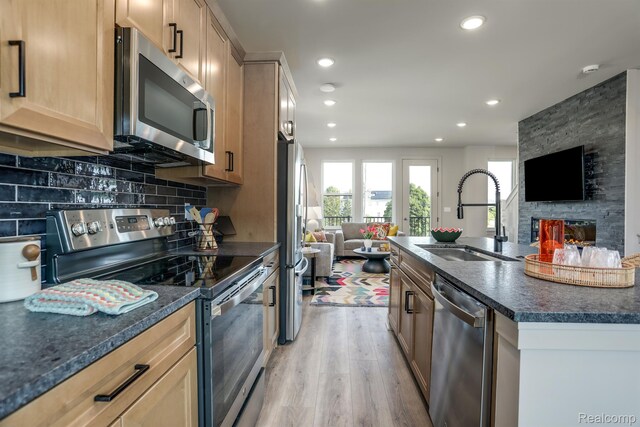 2133 Evergreen Ln Unit 28, Ann Arbor, MI 48103 - kitchen with stainless steel appliances, open floor plan, light wood-type flooring, dark countertops, and recessed lighting