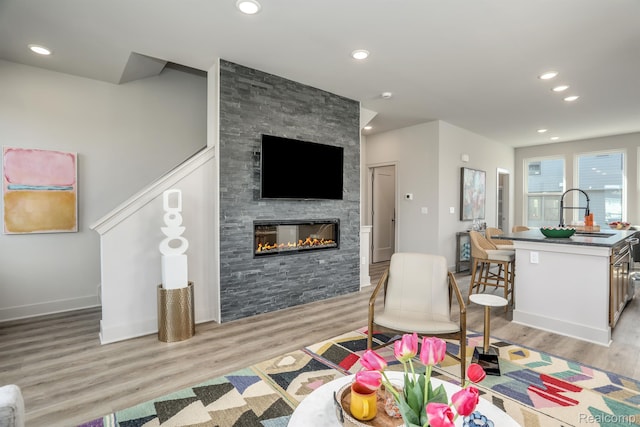 2133 Evergreen Ln Unit 28, Ann Arbor, MI 48103 - living room featuring light wood-type flooring, a fireplace, and recessed lighting