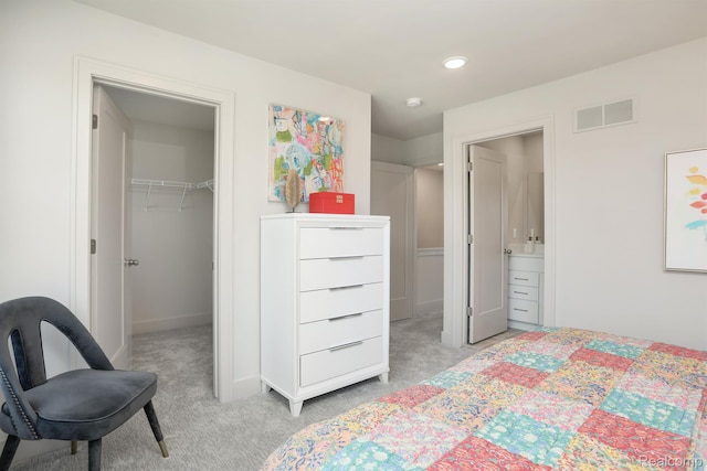 2133 Evergreen Ln Unit 28, Ann Arbor, MI 48103 - bedroom with light colored carpet, a spacious closet, recessed lighting, and a closet