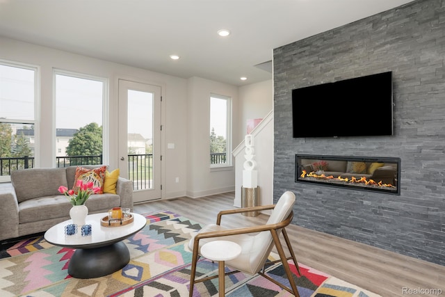 2133 Evergreen Ln Unit 28, Ann Arbor, MI 48103 - living area with wood finished floors, a large fireplace, and recessed lighting