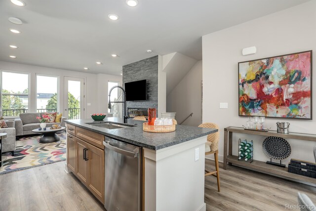 2133 Evergreen Ln Unit 28, Ann Arbor, MI 48103 - kitchen featuring dishwasher, open floor plan, recessed lighting, light wood-type flooring, and dark stone countertops