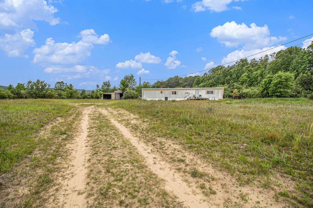 1715 S 48th Ave, Shelby, MI 49455 - view of yard featuring dirt driveway and an outbuilding