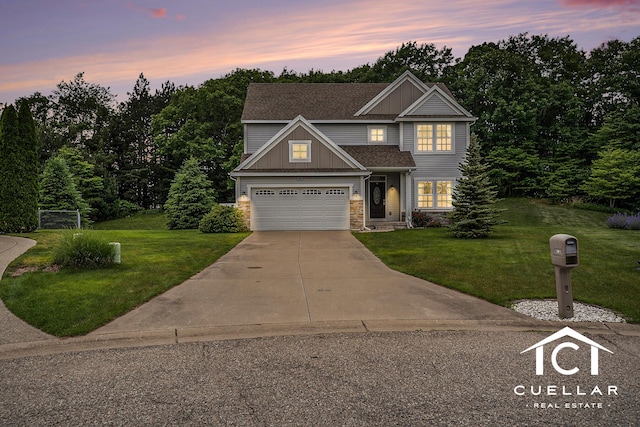9365 Windward Dr, West Olive, MI 49460 - view of front of property featuring driveway, a front lawn, stone siding, board and batten siding, and roof with shingles