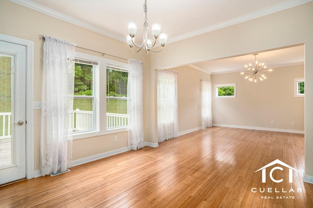 9365 Windward Dr, West Olive, MI 49460 - unfurnished room featuring a chandelier, crown molding, and hardwood / wood-style floors