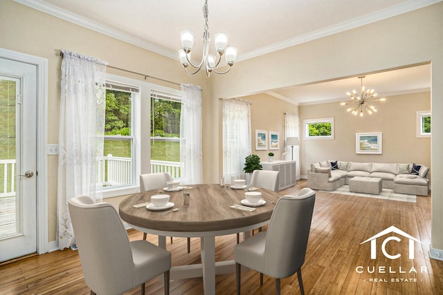 9365 Windward Dr, West Olive, MI 49460 - dining room featuring a chandelier, crown molding, hardwood / wood-style floors, and healthy amount of natural light