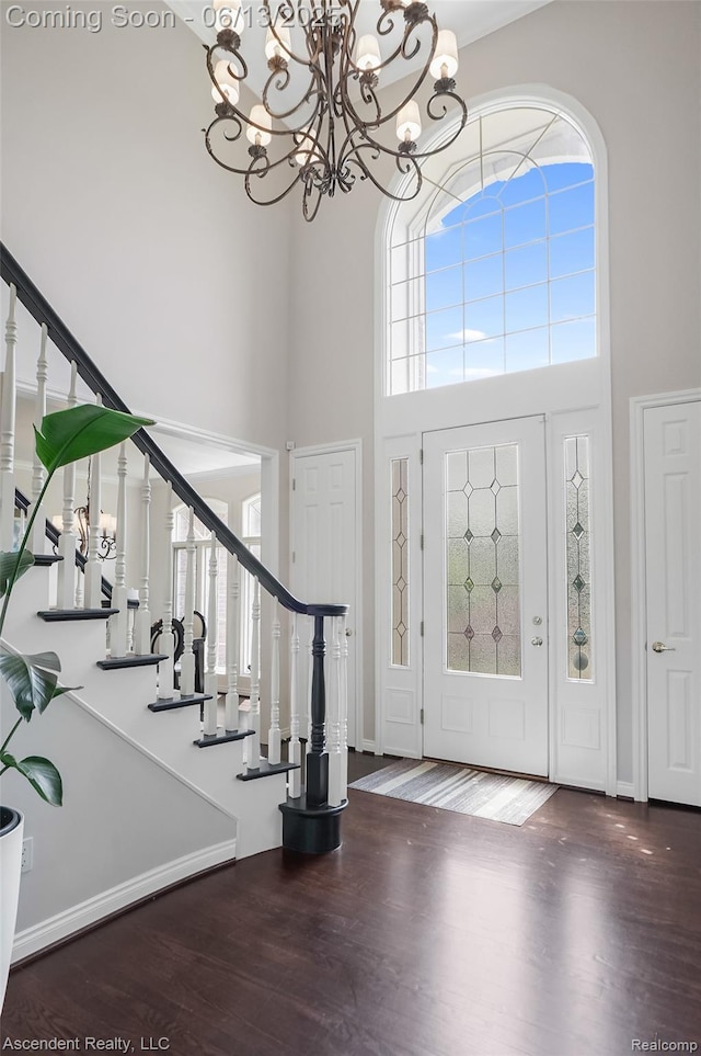 48392 Binghampton Dr, Northville, MI 48168 - entrance foyer with a high ceiling, stairs, wood finished floors, and a chandelier