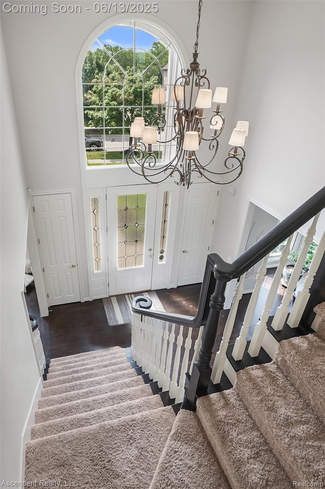 48392 Binghampton Dr, Northville, MI 48168 - entryway featuring a towering ceiling, a chandelier, stairway, and wood finished floors