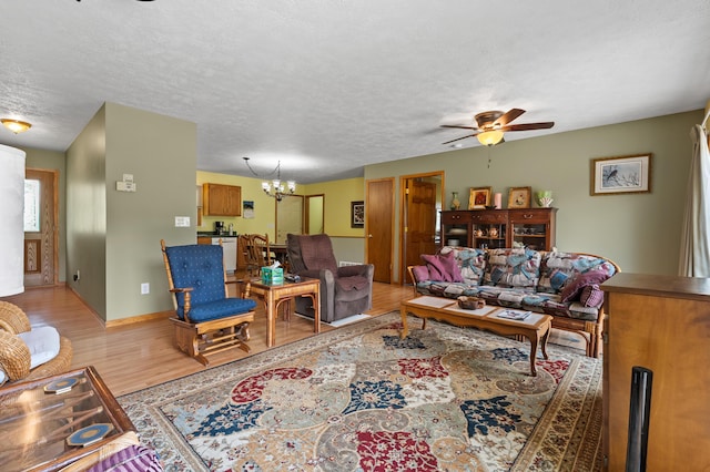 14244 36th St, Gobles, MI 49055 - living area with light wood-style floors, a ceiling fan, a chandelier, and a textured ceiling