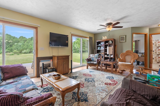 14244 36th St, Gobles, MI 49055 - living area featuring a textured ceiling, ceiling fan, and light wood-type flooring