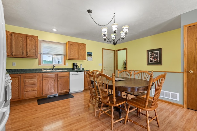 14244 36th St, Gobles, MI 49055 - dining room featuring a chandelier and light wood-type flooring