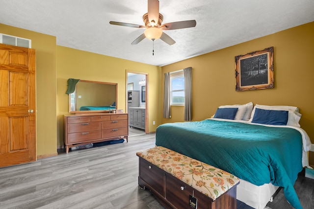 14244 36th St, Gobles, MI 49055 - bedroom with light wood-type flooring, ensuite bathroom, and ceiling fan