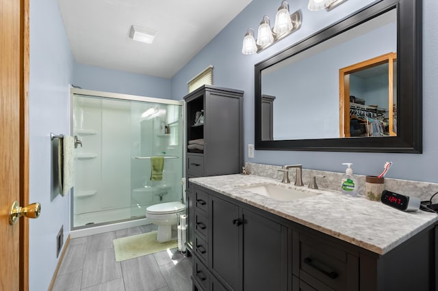 14244 36th St, Gobles, MI 49055 - bathroom with a shower stall, vanity, and a walk in closet