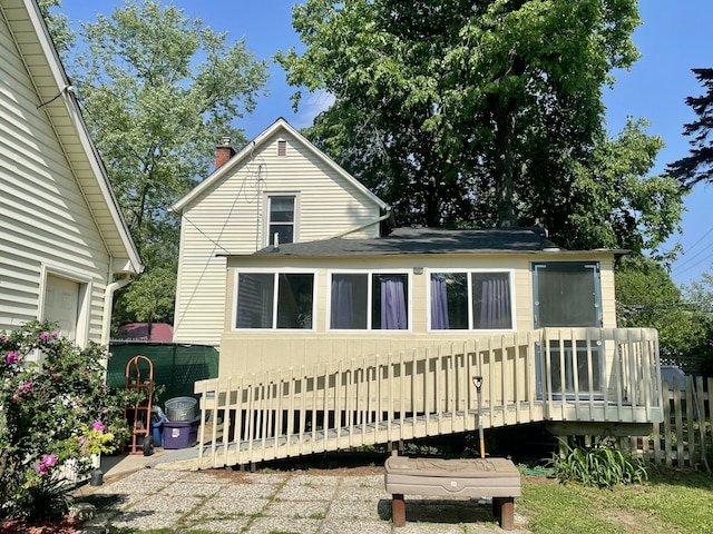 408 Wilkinson St, Chelsea, MI 48118 - rear view of house featuring a deck, a chimney, and a shingled roof