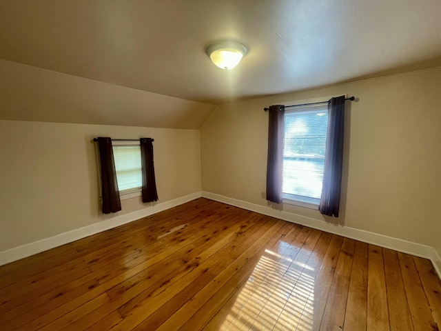 408 Wilkinson St, Chelsea, MI 48118 - bonus room featuring hardwood / wood-style flooring and vaulted ceiling