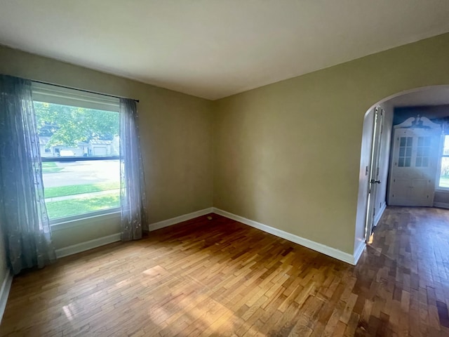 408 Wilkinson St, Chelsea, MI 48118 - spare room with arched walkways and wood finished floors