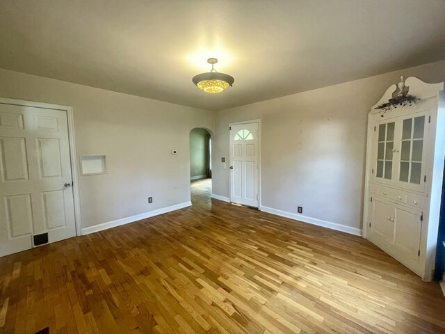 408 Wilkinson St, Chelsea, MI 48118 - spare room with arched walkways and wood finished floors