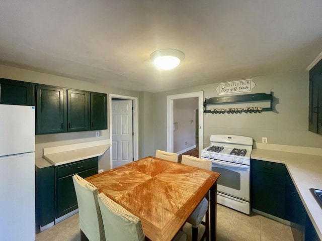 408 Wilkinson St, Chelsea, MI 48118 - kitchen featuring white appliances, green cabinets, light countertops, and light tile patterned floors