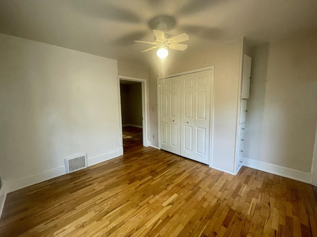 408 Wilkinson St, Chelsea, MI 48118 - unfurnished bedroom featuring wood finished floors, a closet, and a ceiling fan