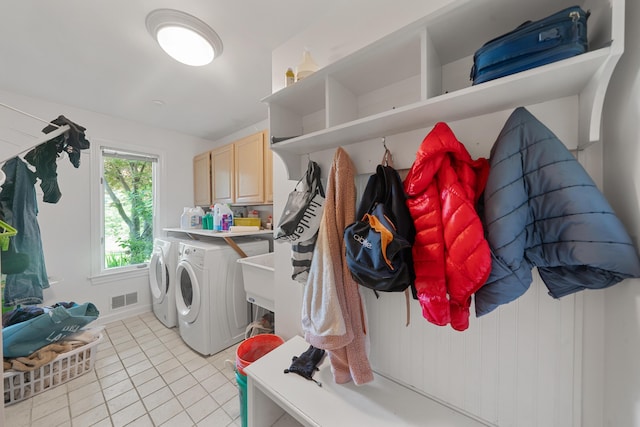 7624 Quail Ridge Dr, Dexter, MI 48130 - laundry room featuring washing machine and clothes dryer, cabinet space, and light tile patterned floors