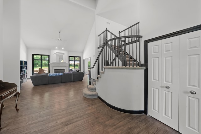 7624 Quail Ridge Dr, Dexter, MI 48130 - staircase featuring high vaulted ceiling, ceiling fan, wood finished floors, and a fireplace