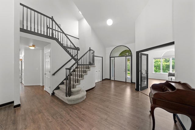 7624 Quail Ridge Dr, Dexter, MI 48130 - entryway featuring high vaulted ceiling, stairs, and wood finished floors