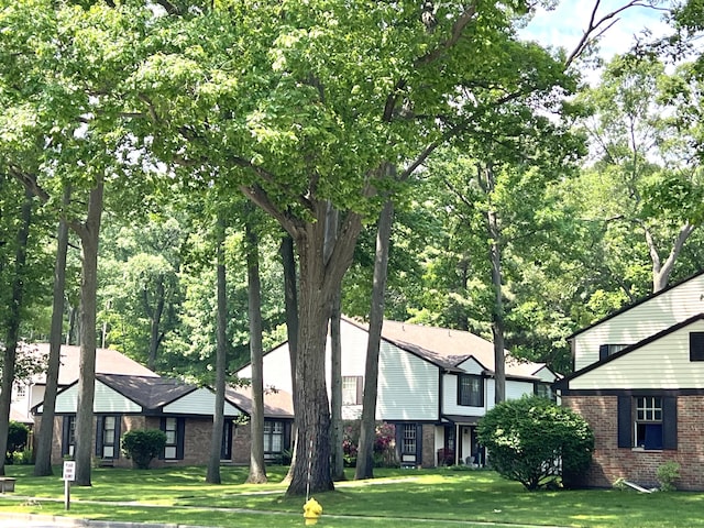 3676 Brentwood St Unit 30, Norton Shores, MI 49441 - view of front facade featuring brick siding and a front yard