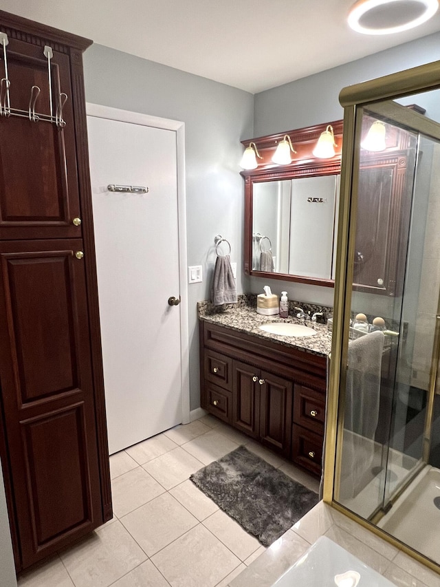 3676 Brentwood St Unit 30, Norton Shores, MI 49441 - bathroom featuring vanity, tile patterned flooring, and a stall shower