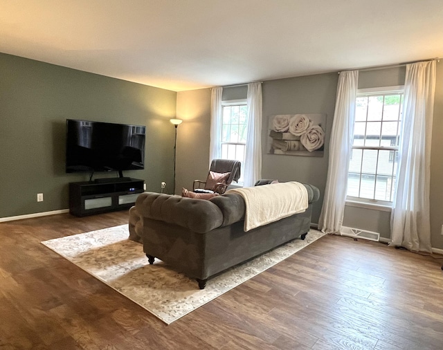 3676 Brentwood St Unit 30, Norton Shores, MI 49441 - living area featuring wood finished floors and healthy amount of natural light