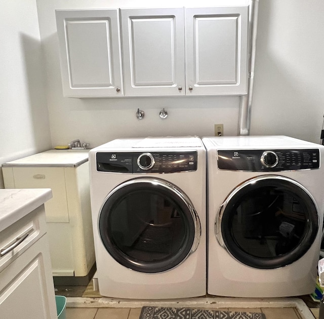 3676 Brentwood St Unit 30, Norton Shores, MI 49441 - laundry room with cabinet space, washing machine and dryer, and tile patterned flooring