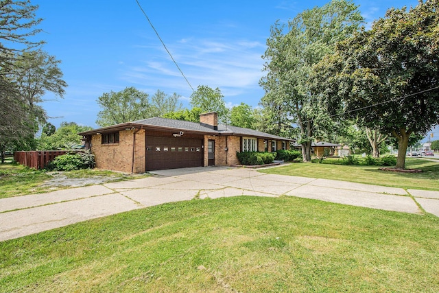 4785 Kalamazoo Ave SE, Kentwood, MI 49508 - view of front of home featuring a garage, concrete driveway, brick siding, and a chimney
