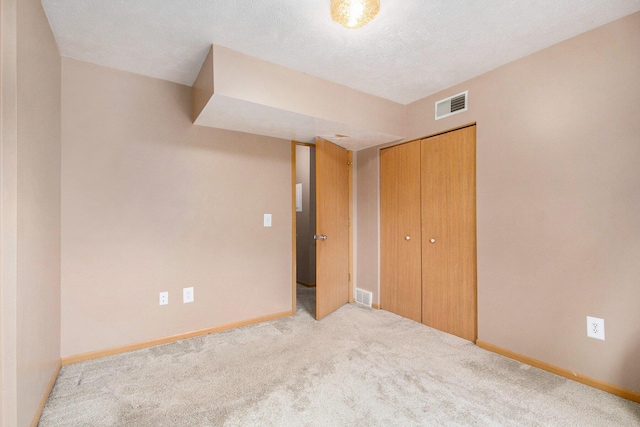 122 Ida Red Ave NW Unit 202, Sparta, MI 49345 - unfurnished bedroom featuring carpet and a closet
