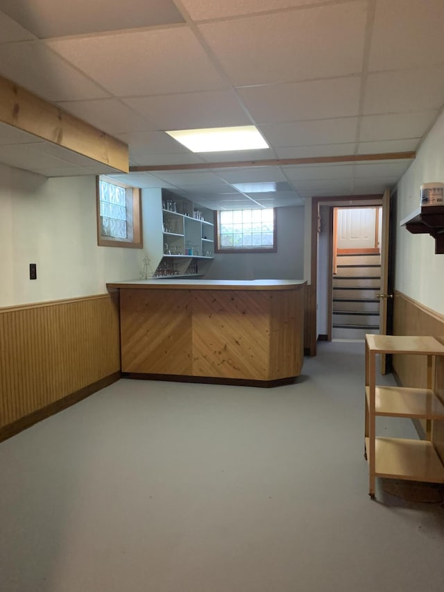 5513 S Waverly Rd, Lansing, MI 48911 - indoor dry bar with wainscoting, stairway, a paneled ceiling, and wooden walls