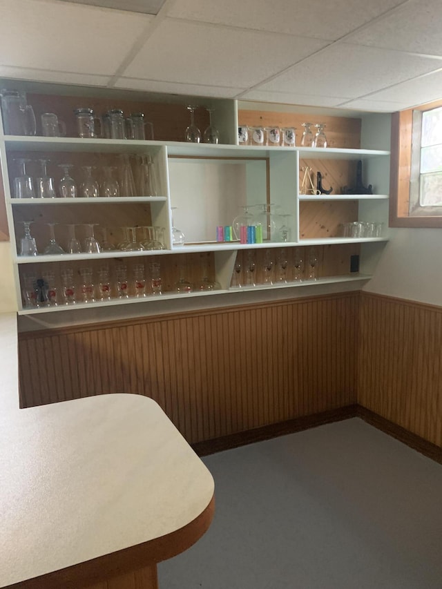 5513 S Waverly Rd, Lansing, MI 48911 - bar with a paneled ceiling, wooden walls, and a wainscoted wall