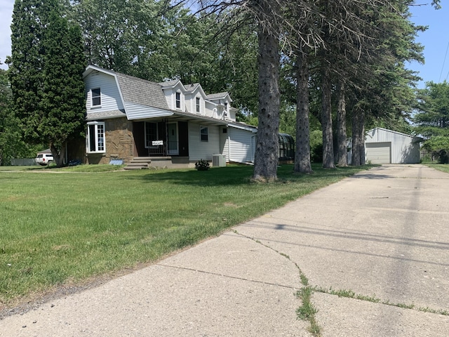 5513 S Waverly Rd, Lansing, MI 48911 - view of front of home featuring a gambrel roof, covered porch, an outdoor structure, a garage, and stone siding