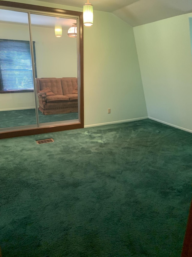 5513 S Waverly Rd, Lansing, MI 48911 - spare room with carpet floors and vaulted ceiling