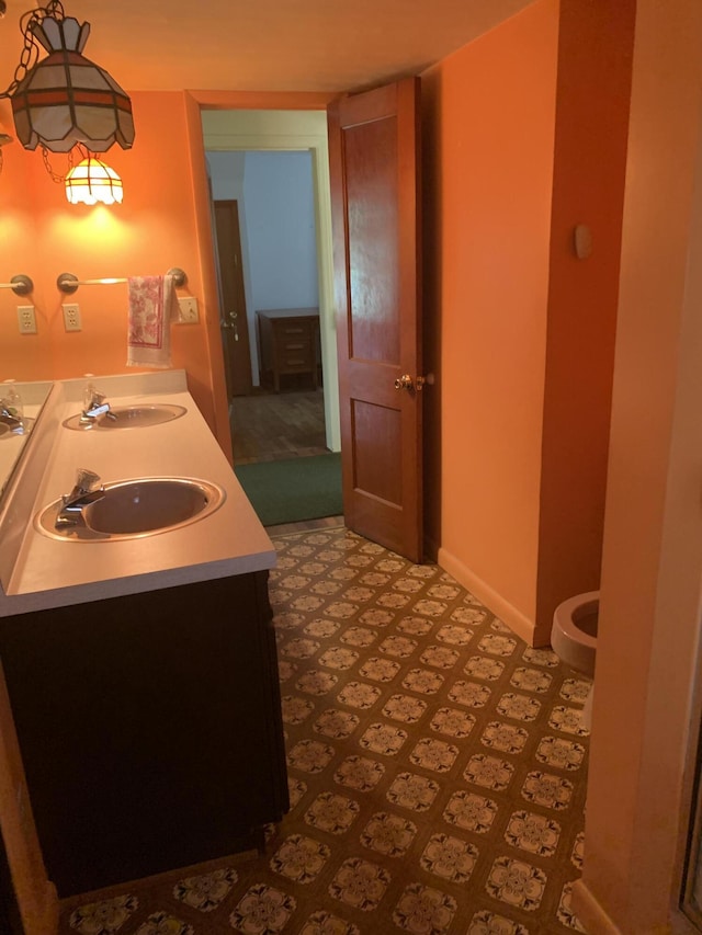 5513 S Waverly Rd, Lansing, MI 48911 - bathroom with double vanity and baseboards