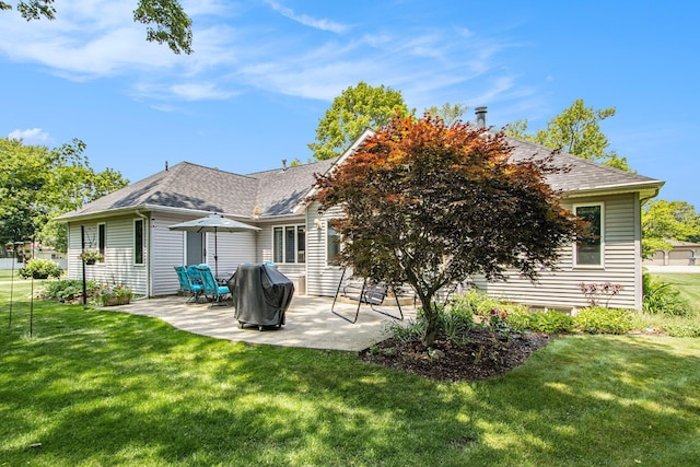 27569 Hawthorne Rd, Sturgis, MI 49091 - back of house featuring a patio, a lawn, and a shingled roof