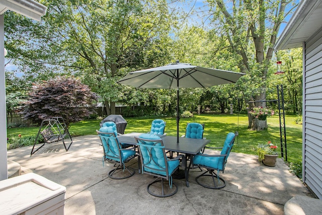 27569 Hawthorne Rd, Sturgis, MI 49091 - fenced backyard with outdoor dining space, a patio, and view of wooded area