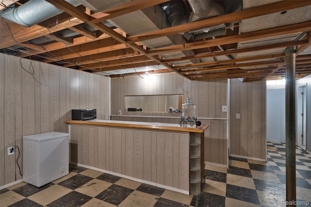 11214 Canal Rd, Sterling Heights, MI 48314 - basement featuring white refrigerator, tile patterned floors, wooden walls, and a dry bar